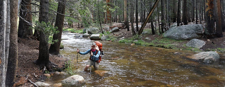 Man hiking through water