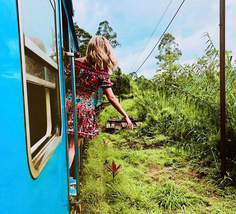 Girl riding Sri Lanka blue train