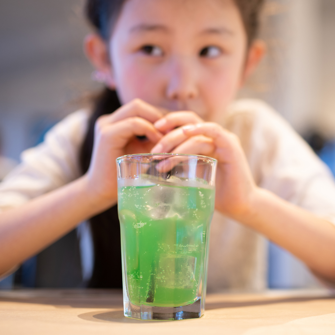 Girl drinking Japanese Melon Soda.