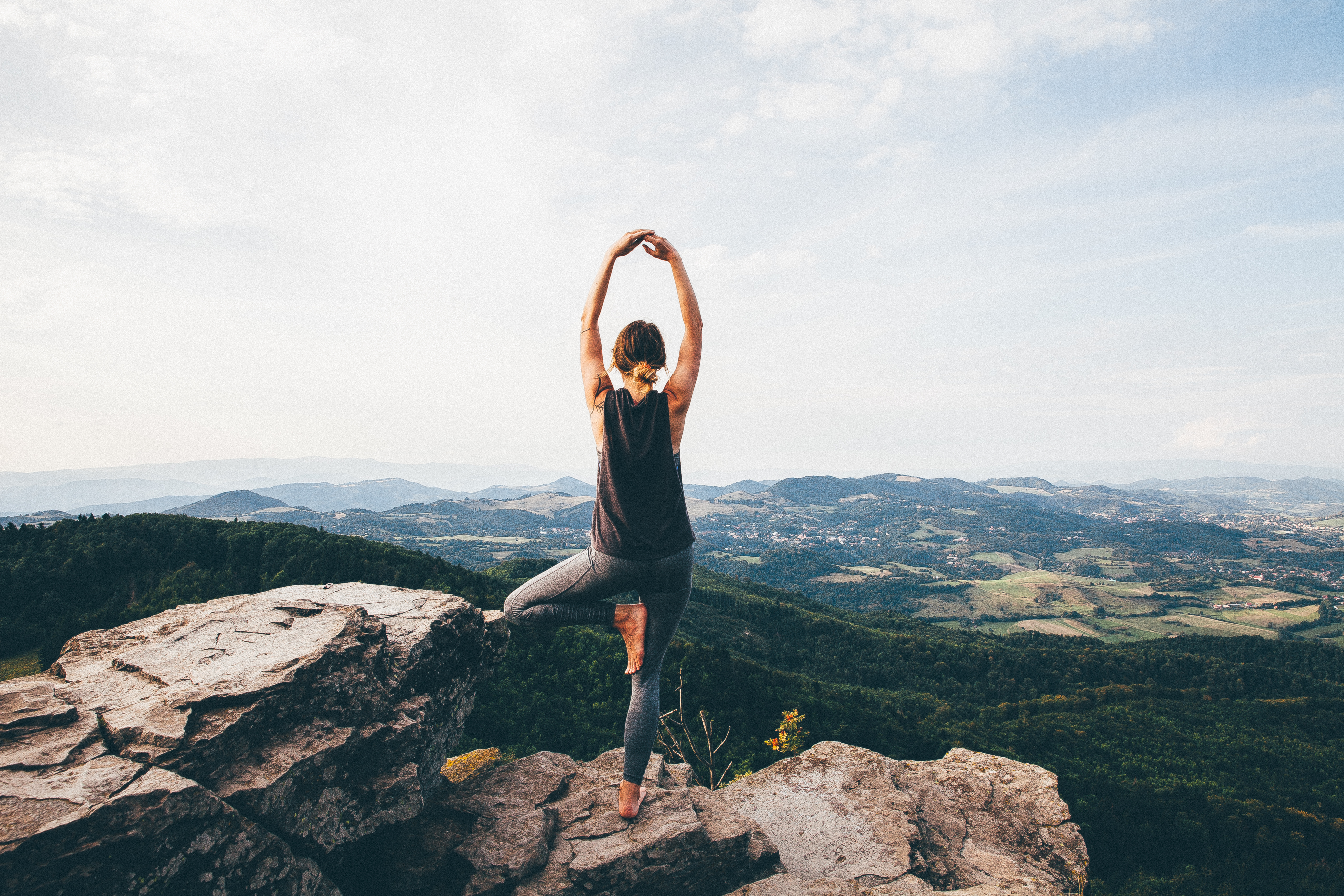 Girl does yoga overlooking canyon