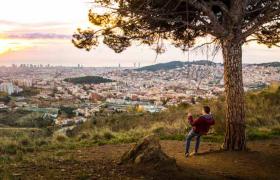 Man on swing looking over Spanish city