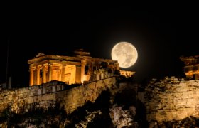 Where to travel based on your star sign. Astrophotography of moon and stars against the ancient Acropolis in Athens, Greece
